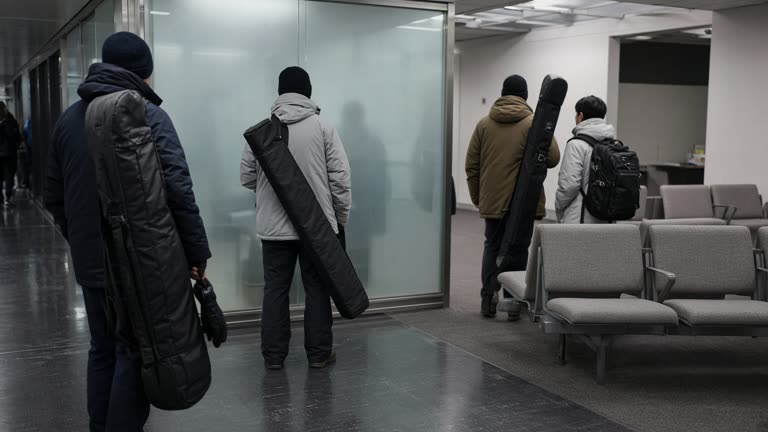 Travelers with ski bags waiting near a generic airport lounge entrance with frosted glass and neutral seating visible inside, cool terminal lighting, no logos or readable text