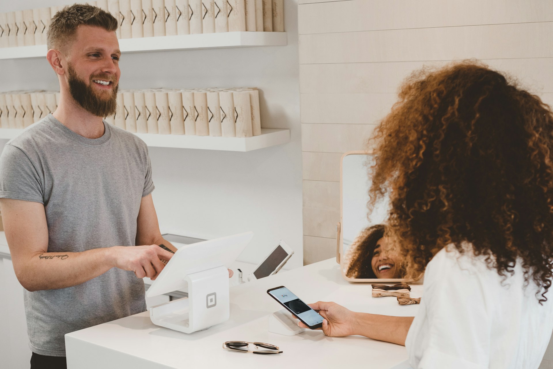 Customer tapping a payment card on a countertop card reader