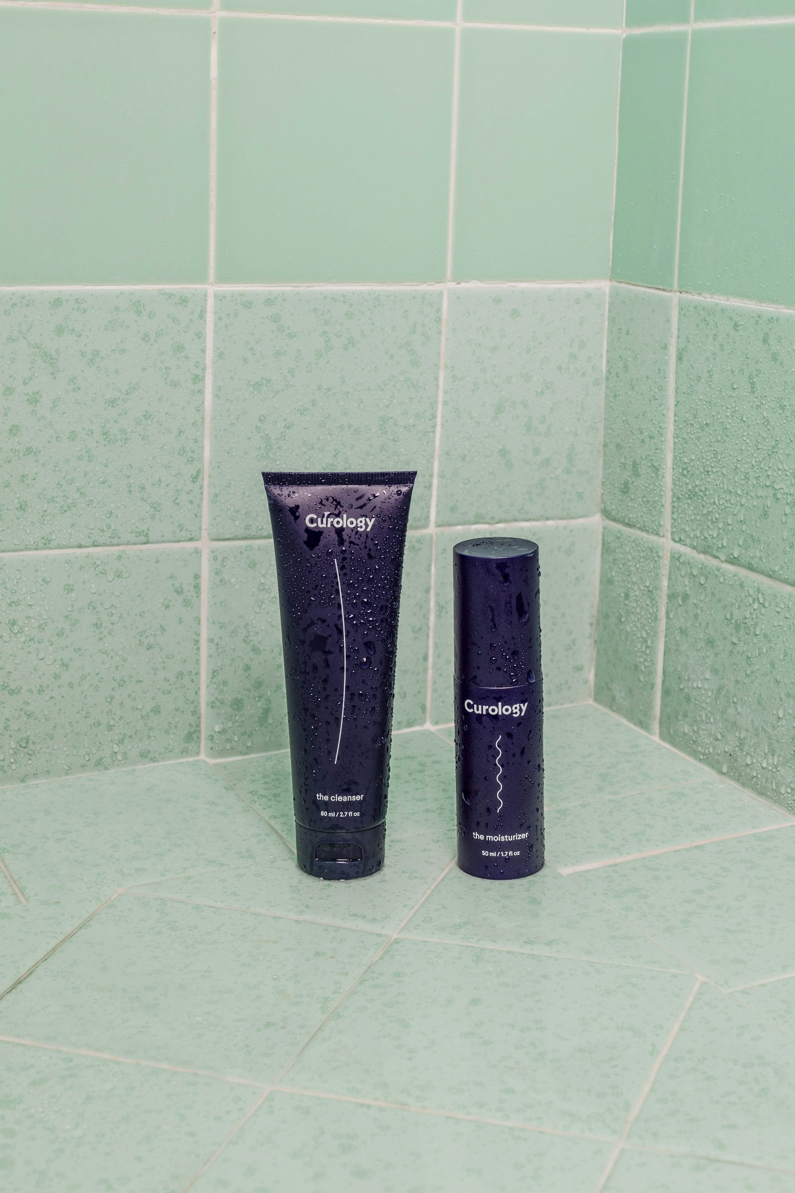 Person applying moisturizer while looking in a bathroom mirror