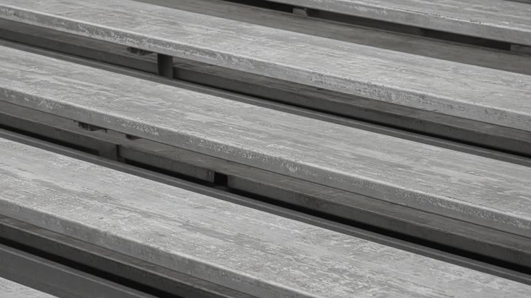 Empty scuffed wooden bleacher plank in overcast daylight, no people, no logos, no readable text
