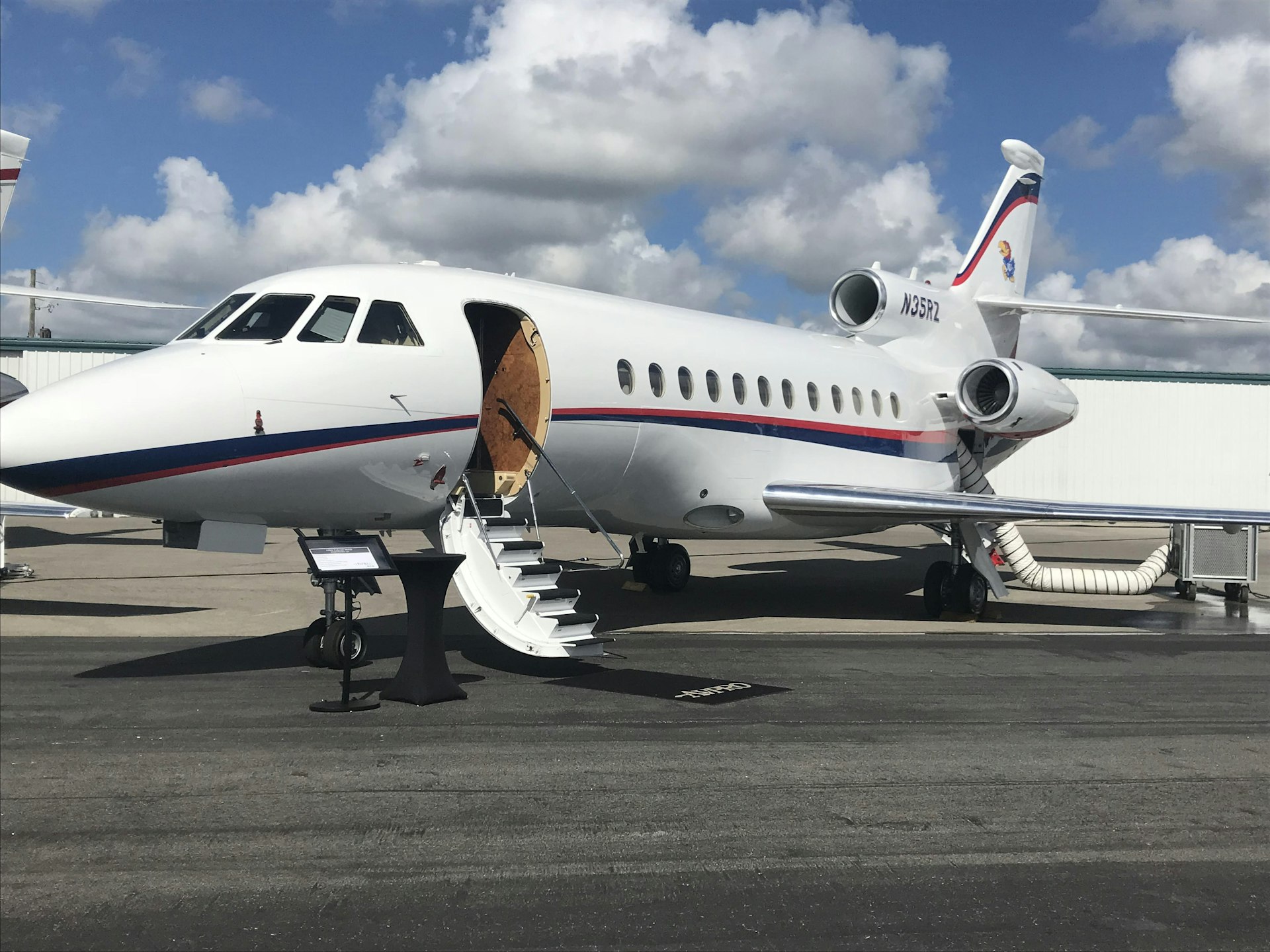 Commercial jet airliner parked at an airport gate under cloudy skies