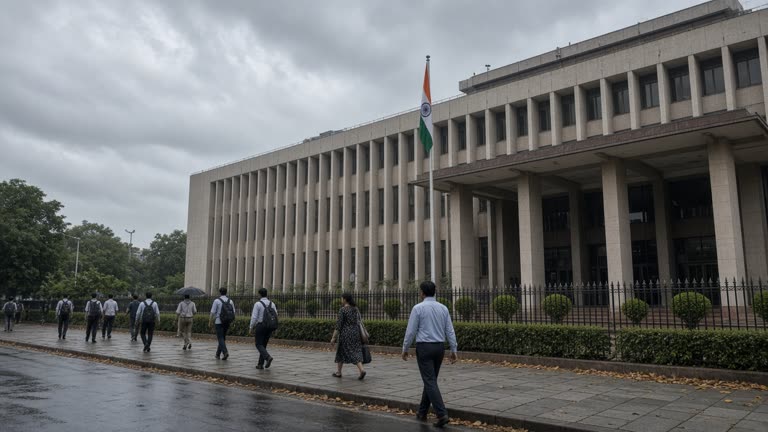 Election Commission of India building facade in New Delhi with tricolor flag, pedestrians on sidewalk, overcast monsoon sky, documentary wire photo, slight underexposure