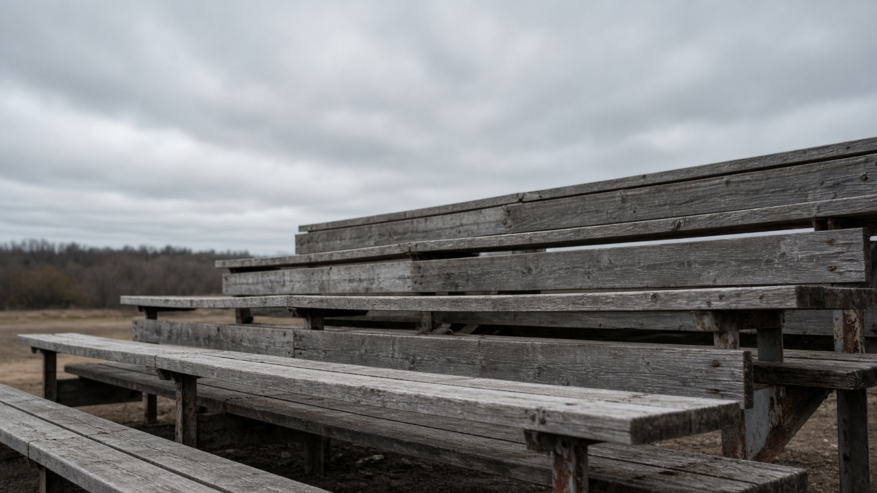 Empty scuffed wooden bleacher plank in overcast daylight, no people, no logos, no readable text