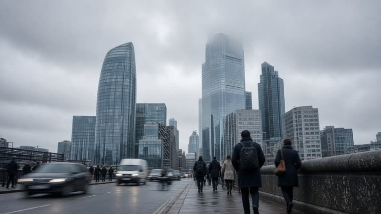 Modern glass office towers in the City of London under low cloud, commuters crossing a bridge, blurred traffic, cool daylight, no readable building logos or text