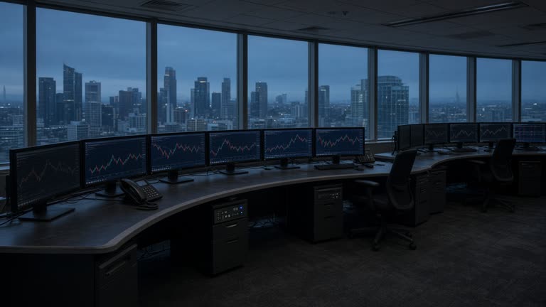 Photoreal wide shot of an empty pre-dawn Australian dealing room, curved desk with dark monitors showing faint unlabelled red and green chart lines, cold blue light through floor-to-ceiling windows over a city skyline, no logos or readable text