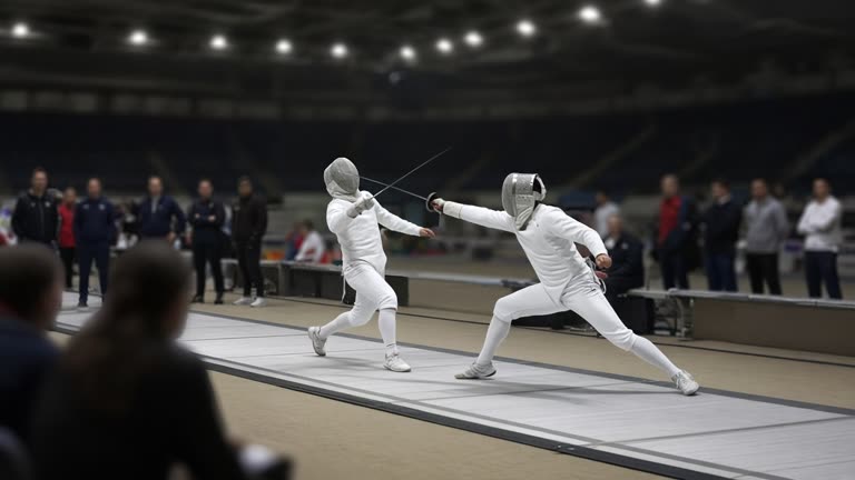 Photoreal arena view of a fencing piste under bright lights, two sabreurs in white gear and masks lunging toward the final touch, blurred coaches and teammates at the edge, no logos or readable text.