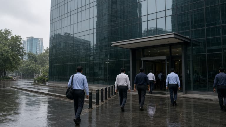 National Stock Exchange building glass exterior in Mumbai Bandra-Kurla Complex with traders entering side entrance, humid haze, wet road reflections, no logos or readable text