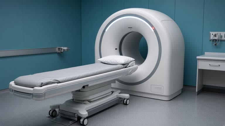 Medical CT scanner room with empty gurney and gantry lights, teal wall panels, no patients and no readable displays