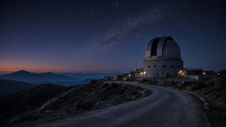 Astronomical observatory dome on a hill at twilight with star fields appearing overhead, concrete access road, no logos or readable text