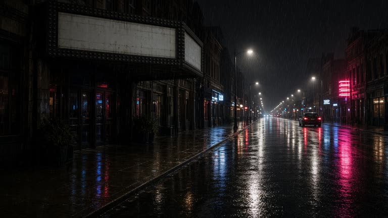 Rain-slick city cinema street at night with a blank marquee frame and neon reflections on wet asphalt, no logos or readable text