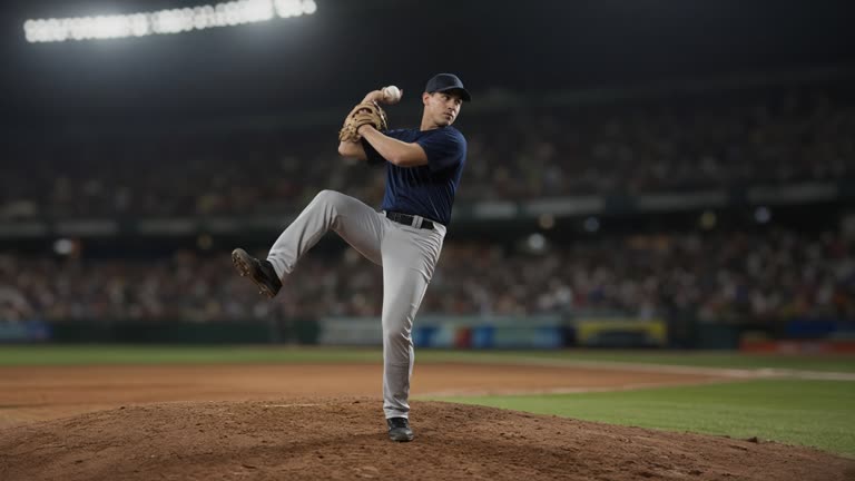 Baseball pitcher on the mound mid-windup under stadium floodlights, blurred infield and dugout in background, no readable uniforms or logos.