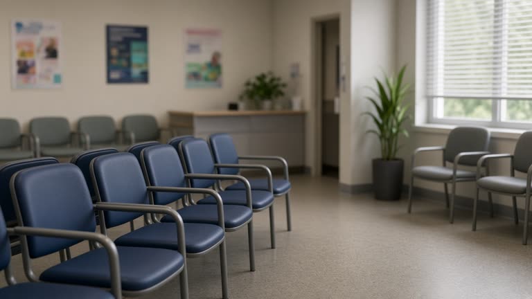 Community medical clinic waiting area with empty chairs and health posters blurred on walls, soft daylight through blinds, no people facing camera, no logos or readable text