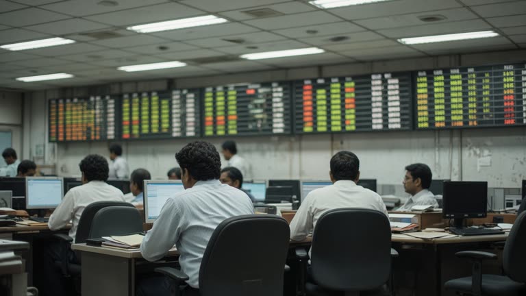 Mumbai stock exchange district trading room with wall-mounted index boards showing blurred numbers, fluorescent ceiling lights, traders at desks from behind, no readable text or logos